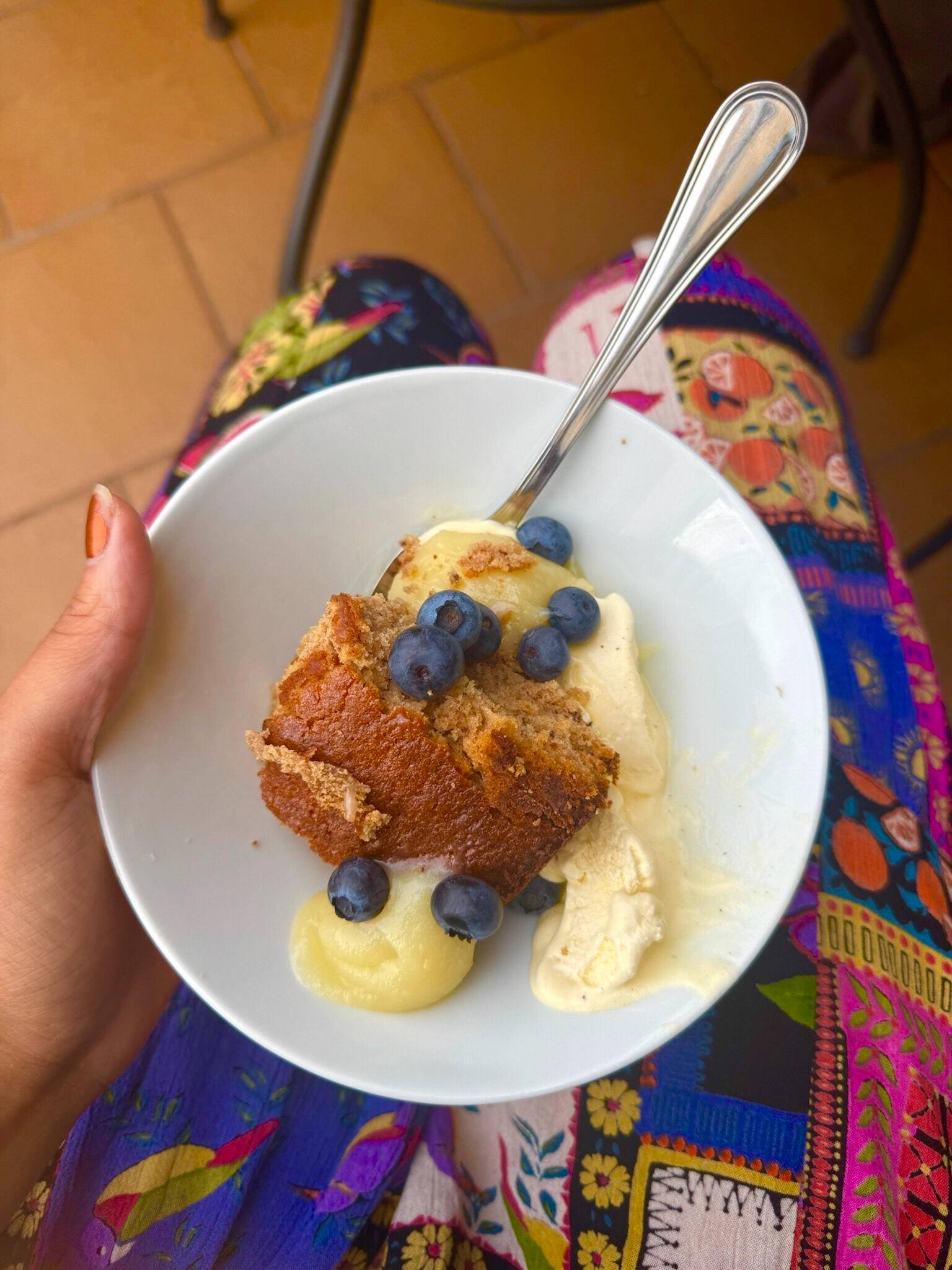 A dessert with vanilla cream and blueberries in a white bowl
