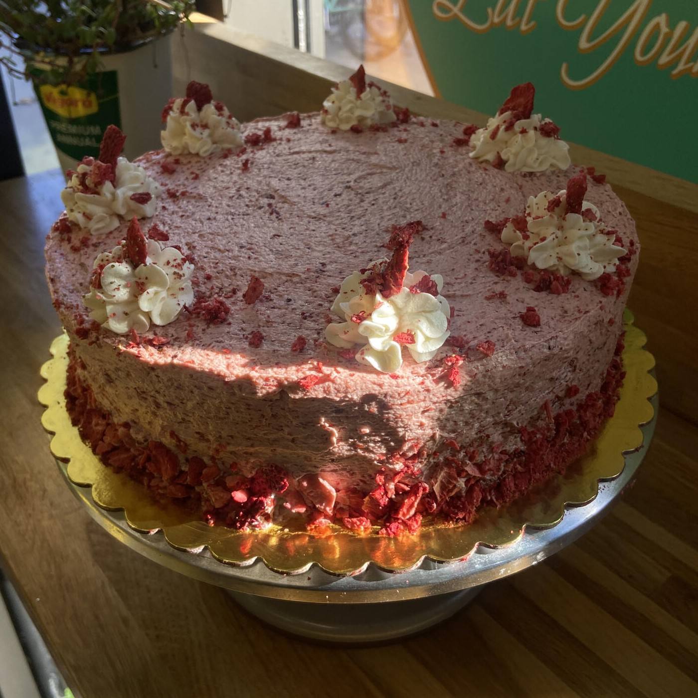 A vegan strawberry shortcake with freeze-dried strawberry crumbles and whipped cream dollops